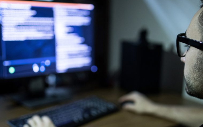 man looking at a pair of computer screens