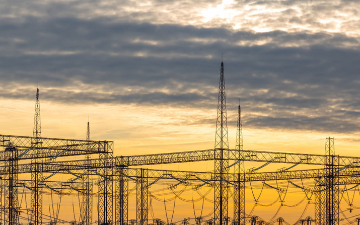 Power lines in front of a sunset