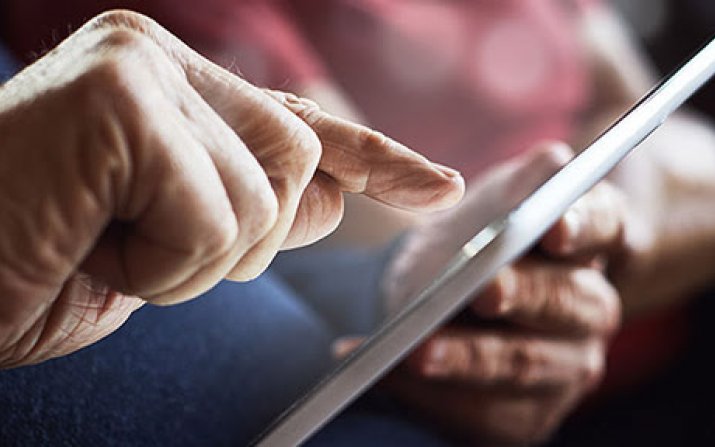 Image of senior citizen using tablet