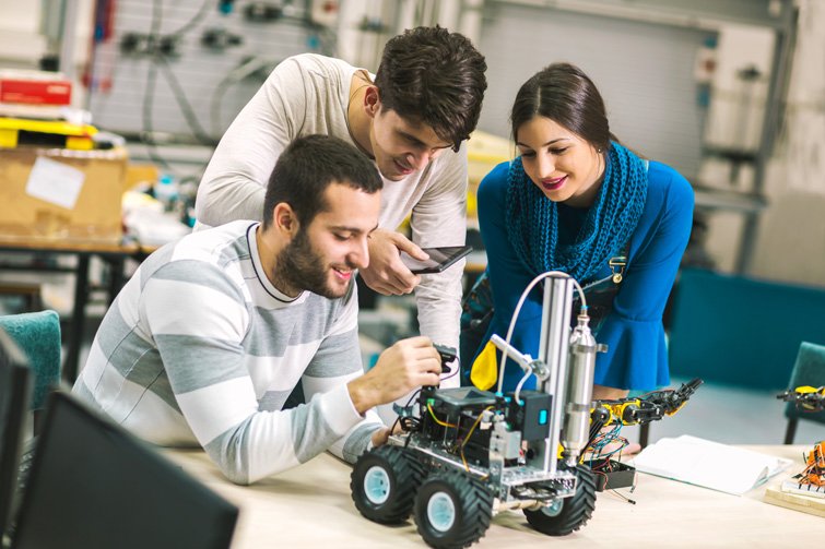 Engineering students working on a robotics project in a lab