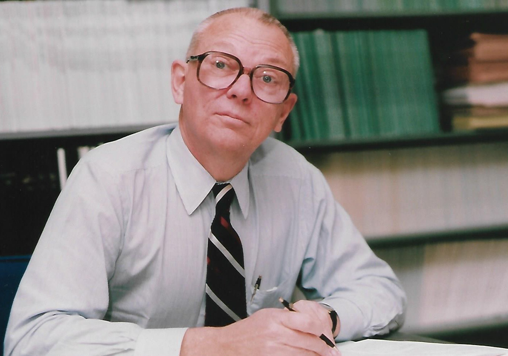 Professor Lucien A. Schmit, Jr. sitting at his desk
