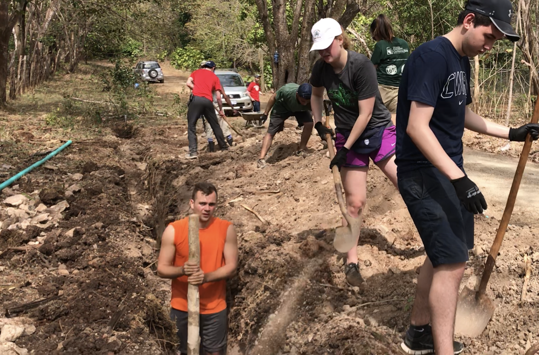 Students dig a ditch in Costa Rica