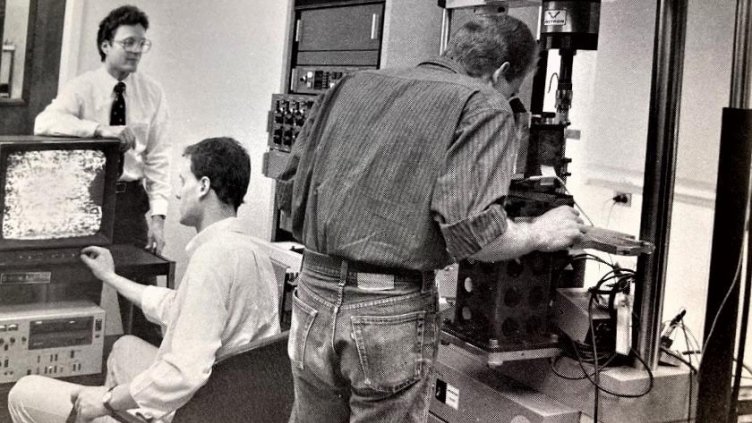 Early in-situ research of fracture behavior in advanced composites on an Instron 1361 electromechanical testing machine capable of test rates as slow as the rate of fingernail growth. Pictured are then Assistant Professor John J. Lewandowski (standing, le
