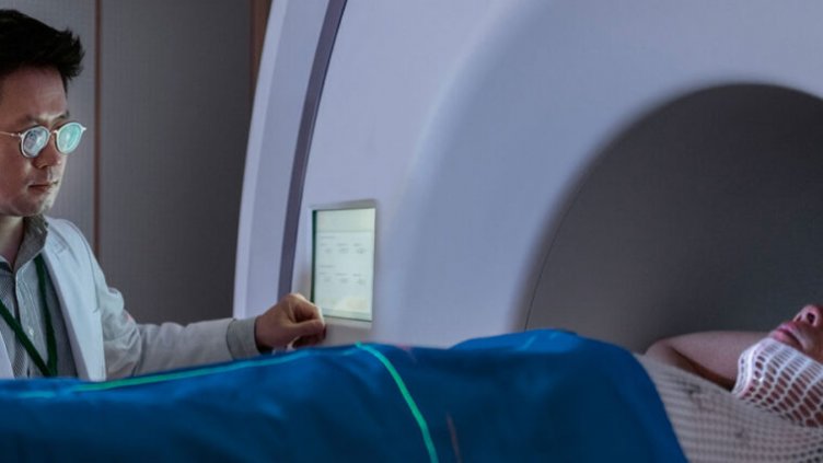 Doctor monitoring patient in MRI