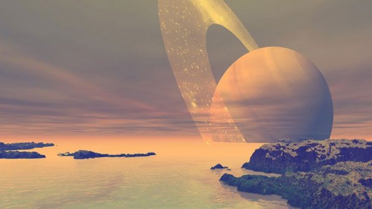 An artist's rendering of the liquefied methane seas of the moon Titan, with a view of Saturn on the horizon