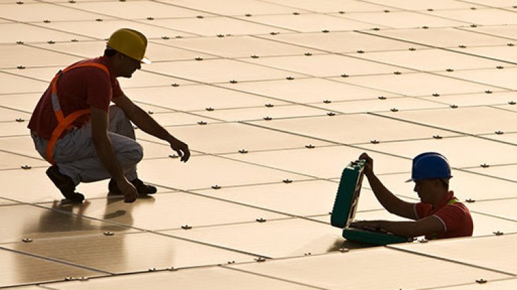 Photo of utility workers working with solar panels