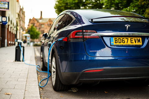 electric car plugged in on street