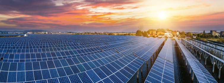 Aerial view of a solar farm at sunset 