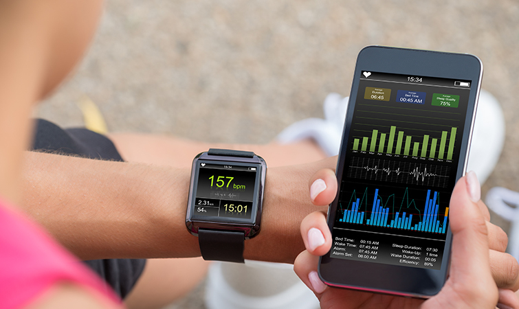 Person looking at their smartwatch with a screen paired to their smartphone 