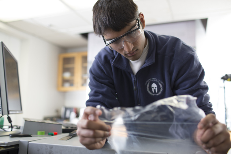 Student researcher working with plastic film