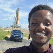 Jamie poses with Artemis I at Kennedy Space Center